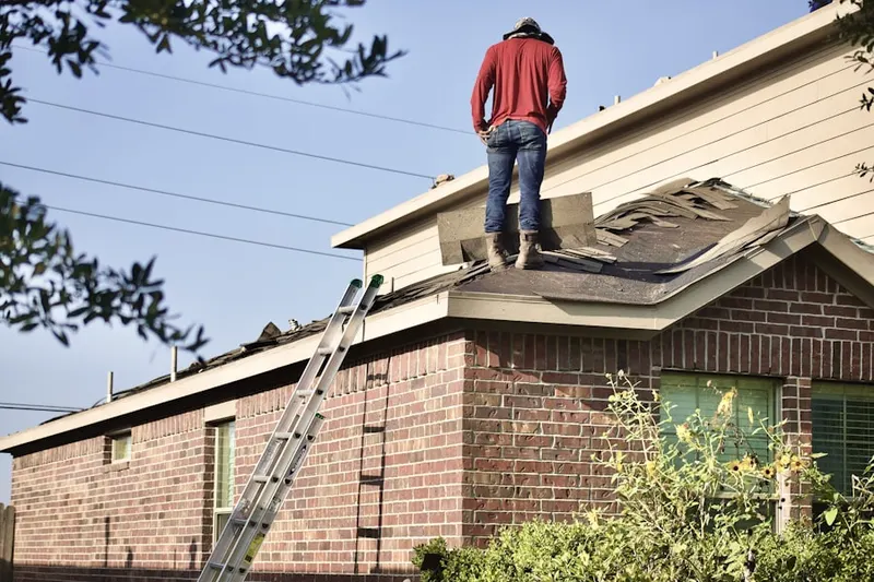 Professional roofer working on a residential roof in Hickory Haven